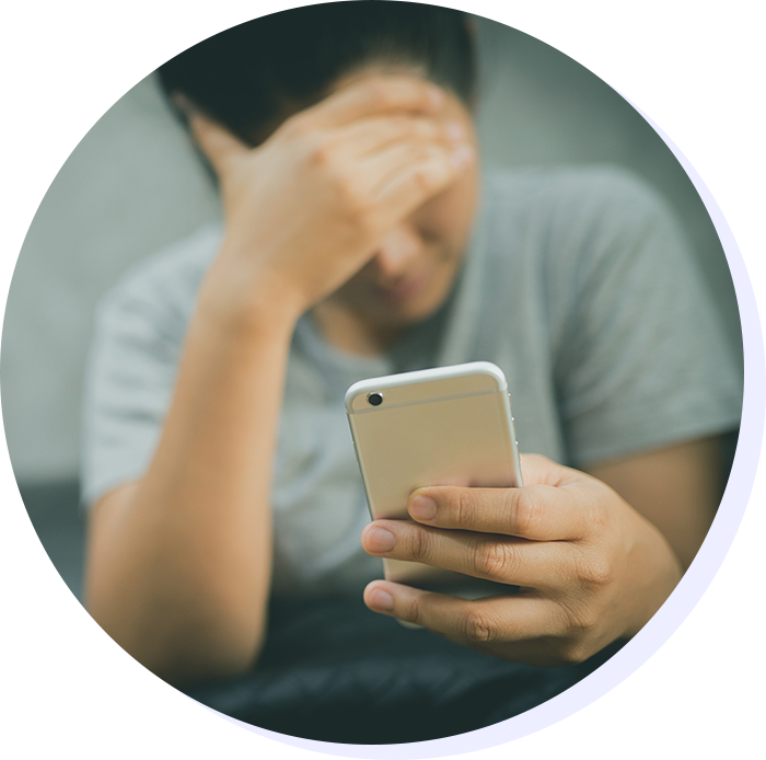 Vtuberにファンを奪われスマホを見ながら落ち込む男性のイメージ画像